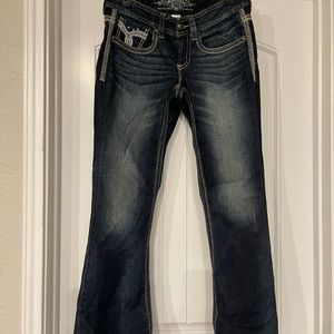 M by Maurices, premium denim. Flap button back pocket jeweled, trendy threading.
